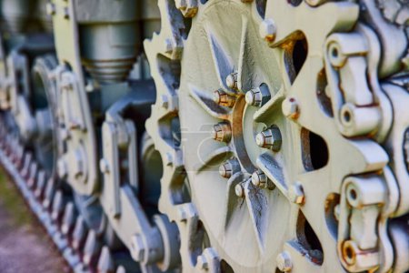 Close-up of tank track gears in Warsaw, Indiana, showcasing robust military engineering and durability.