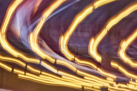 Captivating light trails swirl in vibrant hues, capturing the dynamic essence of urban nightlife.