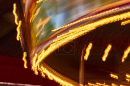 Vibrant long exposure of a carousel in motion at Fort Wayne Childrens Zoo, capturing the thrill and colors of nightlife.