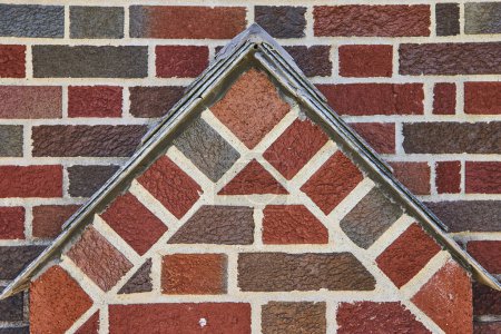 Geometric brickwork with metallic trim in South Wayne Historic District, showcasing craftsmanship and stability.