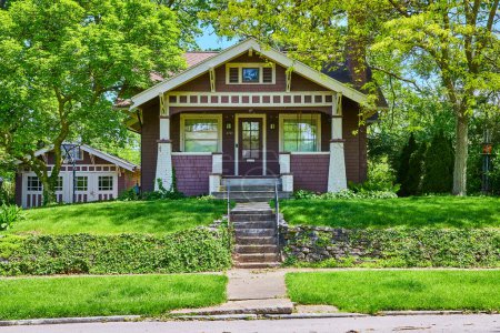 Photo for Charming craftsman bungalow in South Wayne Historic District, Fort Wayne, surrounded by lush greenery. - Royalty Free Image