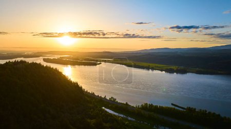 Luftaufnahme der Columbia Gorge in Corbett, Oregon bei Sonnenuntergang. Der majestätische Fluss schlängelt sich durch üppige Wälder und Hügel in der Nähe von Vista House am Crown Point und zeigt die heitere Schönheit der Natur