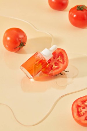 Photo for A bottle of serum is placed next to half a tomato on a transparent acrylic sheet. The concept of homemade cosmetics with natural ingredients that are safe for the skin. - Royalty Free Image
