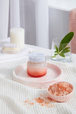 Photo for Blank label featured on round tray, decorated with a bowl of pink himalayan salt, scented candle and a brush. Pink himalayan salt contains more than 84 minerals and elements - Royalty Free Image