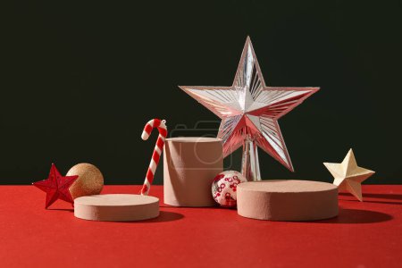 Photo for Minimal scene for products showcase with Christmas concept. Stars, candy cane and baubles decorated with cylinder podiums on black and red background. Space for display product - Royalty Free Image