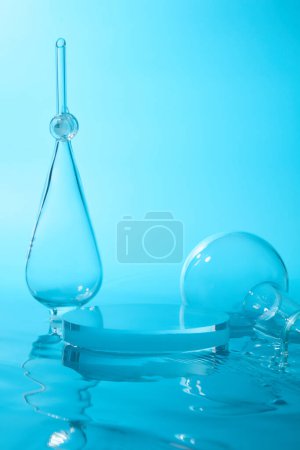 Photo for Laboratory equipment arranged with transparent podium with blank space. Geometric shapes podium for product display. Blue background - Royalty Free Image