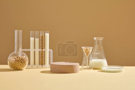 Photo for Some types of laboratory glassware containing soybean seeds and milk arranged with a brown podium. Pedestal or platform for beauty products presentation - Royalty Free Image