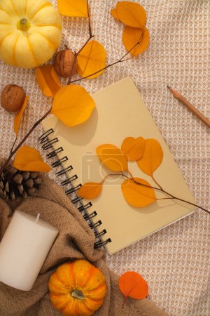 Photo for Autumn background with dry leaves, pumpkins and decorative notebooks on vintage fabric. Top view, autumn concept waiting for the upcoming Thanksgiving holiday - Royalty Free Image
