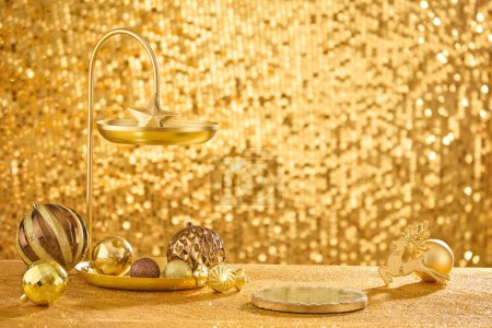 Photo for Bronze tray with two tiers containing lots of baubles displayed over golden background. Round-shaped podium with empty space for product or goods promotion - Royalty Free Image
