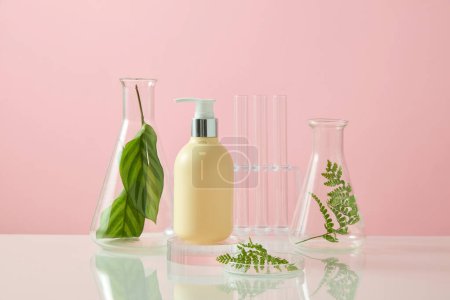 Photo for Unbranded pump bottle displayed with a petri dish, conical flasks and few test tubes. Natural beauty blank label for branding mock-up concept - Royalty Free Image