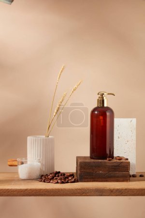 Photo for Beige wall background with pump bottle on wooden podium, coffee beans and bath salt on wooden pedestal. Empty label for design. Mockup for design, organic cosmetics, beauty products concept - Royalty Free Image