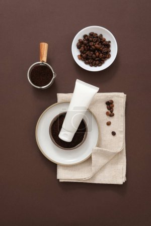 Photo for Minimal scene for advertising and branding cosmetic with coffee ingredient. Coffee beans and coffee powder on ceramic props decorated with white plastic tube mockup for design - Royalty Free Image