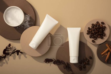 Photo for Mockup bottle of cosmetic displayed on round podiums with coffee beans, bath salt and cinnamon sticks on brown background. Top view, concept for advertising organic cosmetics - Royalty Free Image