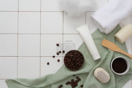 Photo for Creative frame for advertising and branding product with bathroom concept. A white cosmetic tube with bowls of beans and powder coffee decorated on white ceramic background with green towel - Royalty Free Image