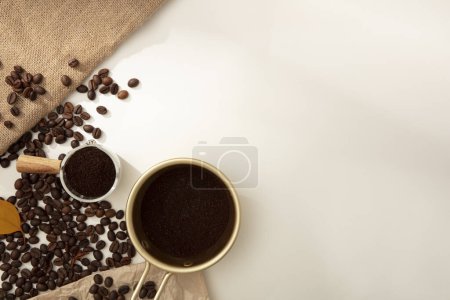 Téléchargez les photos : Fond de bannière minimale créative à partir de grains de café. Sur fond blanc, des grains de café torréfiés bruns et de la poudre de café décorés. Espace vide pour la conception ou la copie - en image libre de droit