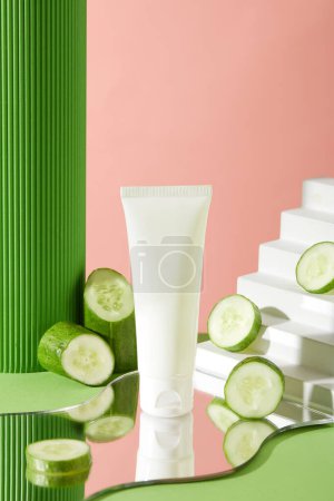 Photo for Cosmetic tube without label standing on a mirror, decorated with cucumber round slices and a staircase. Natural beauty blank label for branding mock-up concept - Royalty Free Image