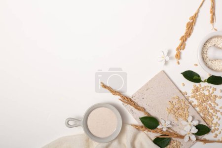 Photo for Rice bran and props on white background. Ideal space for displaying products with main ingredients from rice bran. Pure rice bran does not contain lactose, gluten and does not cause allergies. - Royalty Free Image