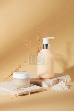 Photo for Front view of a jar of lotion and a bottle of shower gel are placed on a podium with rice bran powder on a beige background. Skin care with natural ingredients. - Royalty Free Image