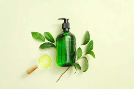 Photo for Green, transparent bottle with soap pump on pastel background. Cosmetic vial wish shampoo,gel. Elements, template for cosmetic business. Mockup for cosmetic advertising. - Royalty Free Image