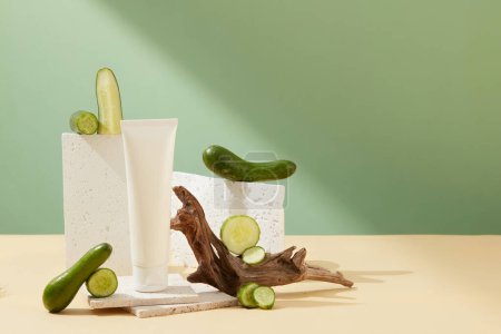 Photo for Empty cosmetic tube decorated with cucumber and props on a pastel background. Advertising concept of natural cosmetics and skin care. - Royalty Free Image
