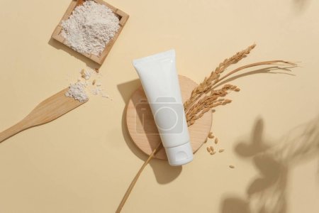 Photo for Unbranded cosmetic tube highlights on a minimalist beige backdrop. Crafting a vegan cosmetics brand with primary ingredients sourced from rice bran. Ample copy space. - Royalty Free Image