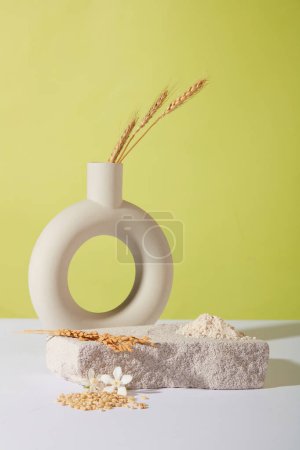Photo for A uniquely shaped flower vase and whole grain rice are displayed on a stone platform. Delicate pastel background suitable for cosmetics advertising. Copy space. - Royalty Free Image