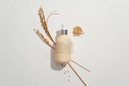 Photo for Top view of an unlabeled shower gel bottle mockup displayed on a white background with whole grain rice. Skin care with natural products - safe and benign. - Royalty Free Image