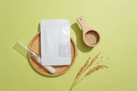 Photo for Whole grain rice is stored in a test tube and a mask sheet on a round wooden tray. Rice bran contains Squalene, an ingredient that helps keep skin moisturized and maintains skin elasticity. - Royalty Free Image