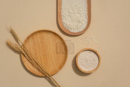 Photo for Wooden plates with different shapes and whole rice are displayed on the background. With vitamins B6, B12,etc and minerals, brown rice can help make skin smooth and firm. - Royalty Free Image