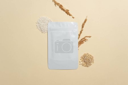 Photo for Facial mask package decorated with wheat seeds, rice and wheat ears. Rice bran has been used for centuries in Japan as a key ingredient in cleansers - Royalty Free Image