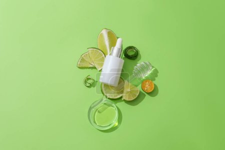 Photo for Close-up of an unbranded serum jar on green background with fresh lemon. Light yellow liquid in petri dish. Creative space for cosmetic advertising. Mockup vegan cosmetic. - Royalty Free Image
