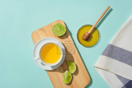 Photo for On a wooden tray, a cup of tea featuring lemon and honey, providing a blank canvas for design. Embrace the health benefits of honey tea to enhance overall well-being. - Royalty Free Image