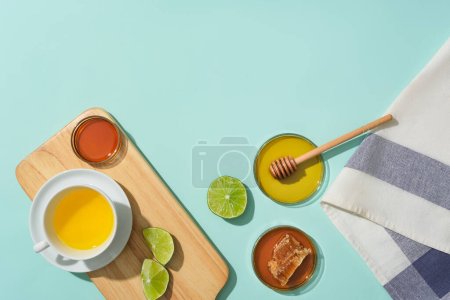 Photo for A cup of tea with main ingredients from lemon and honey is placed on a wooden tray. Blank space for design. Use honey tea to improve health condition. - Royalty Free Image