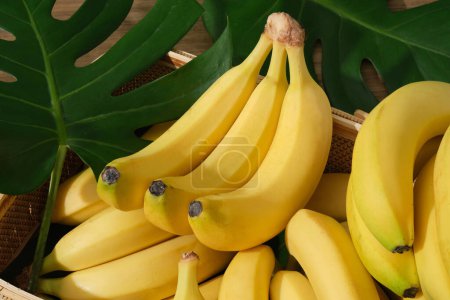 Close-up view of a banana bunch placed on top of many bananas below. Banana (Musaceae) is great for your skin as well as your overall health