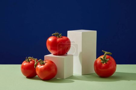 Photo for Scene for display of organic natural cosmetic products - empty podium and fresh tomatoes on a color background. Blank space to display packaging mockup - Royalty Free Image