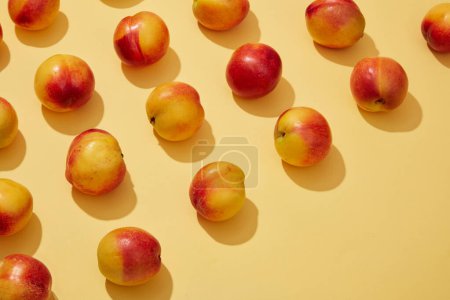 Photo for Flat lay composition with ripe peaches (prunus persica) on yellow background and blank space for text or design. Regularly eating peaches can promote heart health - Royalty Free Image