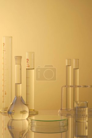 Minimal concept with laboratory glassware - test tubes and beaker filled transparent liquid, petri dishes upside down form an empty platform to display products. Front view