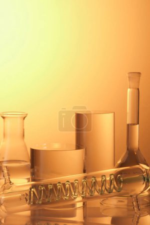 Laboratory glassware containing transparent liquid and transparent cylinder podiums on golden background. Blank space for display product with minimal concept.