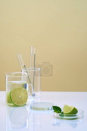 Blank minimalist background for lime extract cosmetic presentation with laboratory concept. Lime slices in beaker and petri dish, test tubes and transparent podium on color background.