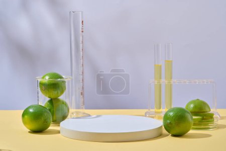 Front view of fresh limes decorated with lab glassware and round empty podium on white background with natural shadow leaves. Minimal empty display product presentation scene.