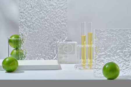 Photo for Front view of fresh limes, lab glassware containing yellow liquid, acrylic sheets and empty podium on white background. Scene for advertising cosmetic with nature ingredient for skin care. - Royalty Free Image
