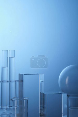 Transparent liquid contained inside laboratory glassware with empty area for text or product presentation. Concept laboratory tests and research natural extract making cosmetics