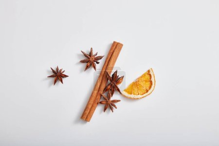Photo for Top view, flat lay of cinnamon stick, anise and dried orange slice isolated on white background. These are herbs good for health, heart, skincare and haircare. - Royalty Free Image