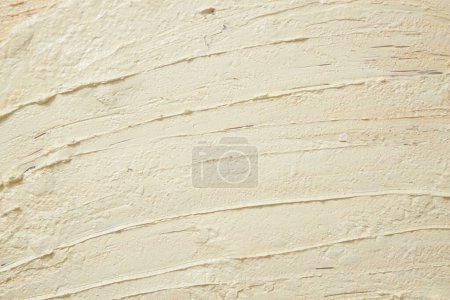Beige texture of cream with ingredients from pineapple (Ananas comosus). Background for design and advertising cosmetic, lotion or exfoliate. Copy space