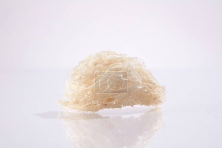 Photo for Close up of raw bird's nests isolated on white background. Food of natural origin, expensive culinary ingredient for health - Anti-aging, brighten skin, prevent melasma, freckles effectively - Royalty Free Image