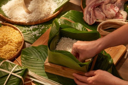 Photo for Vietnamese traditional Chung cake with dong leaves, pork glutinous rice for holiday food advertising. Traditional lunar new year food - Royalty Free Image