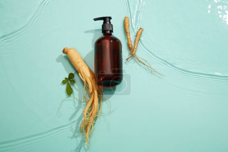Photo for Mockup scene with empty bottle for cosmetic of ginseng extract on blue background. Water surface and a few small ripples. Empty space for text and design. - Royalty Free Image