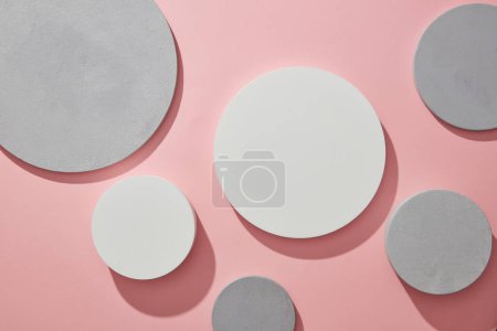 Background for display cosmetics with white and gray round empty podiums on trendy pink. Backdrop illustration for advertising. Top view, flat lay.