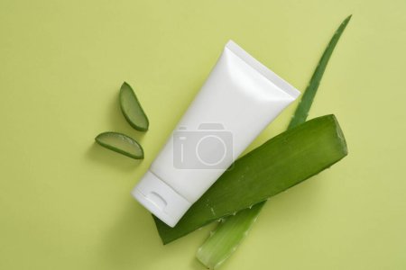 Aloe vera (Aloe barbadensis miller) cut in half lengthwise arranged with a tube. Packaging for cream, gel, lotion advertising and product promotion, mock up