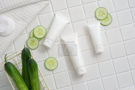 Photo for A basket of Cucumber arranged with unlabeled tubes, Cucumber slices and cotton pads. Cucumber (Cucumis sativus) helps combat premature aging. Skin care product mockup - Royalty Free Image